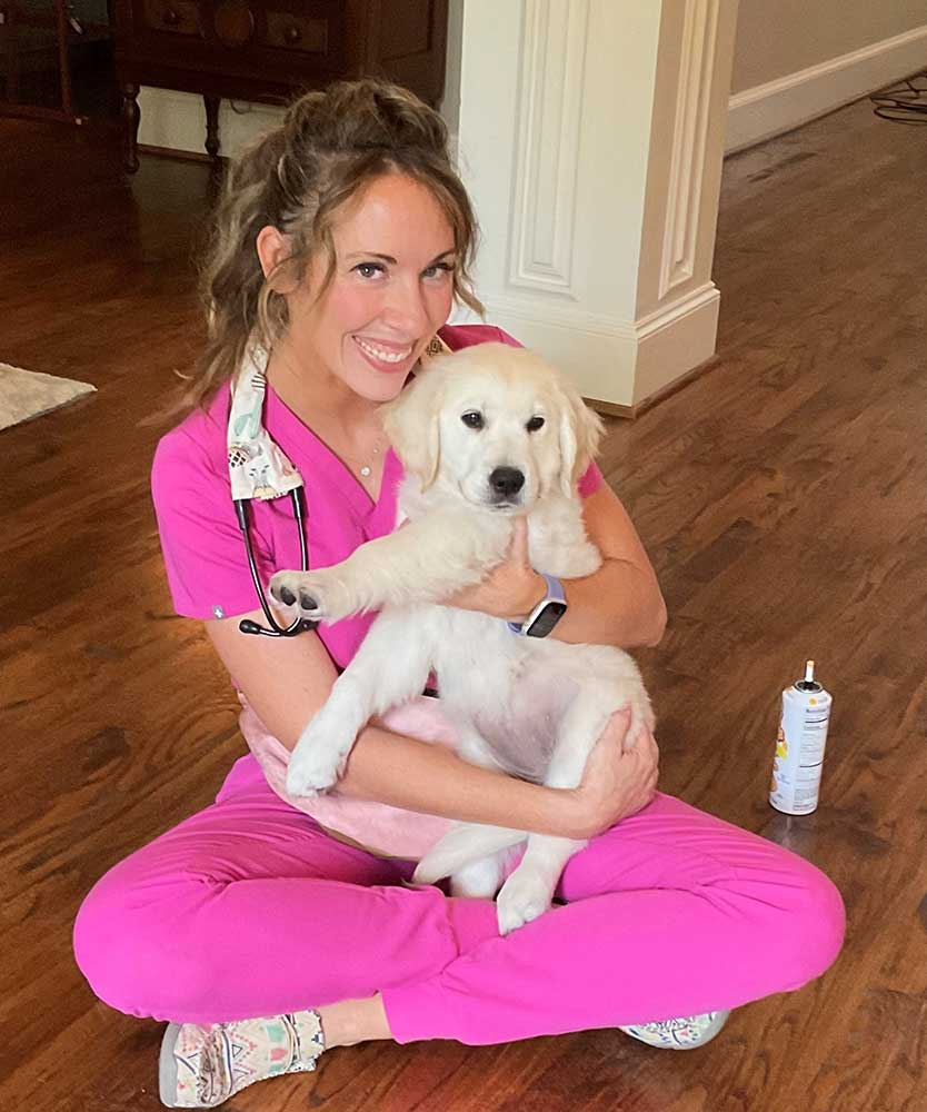 Dr. Ashley holding a puppy