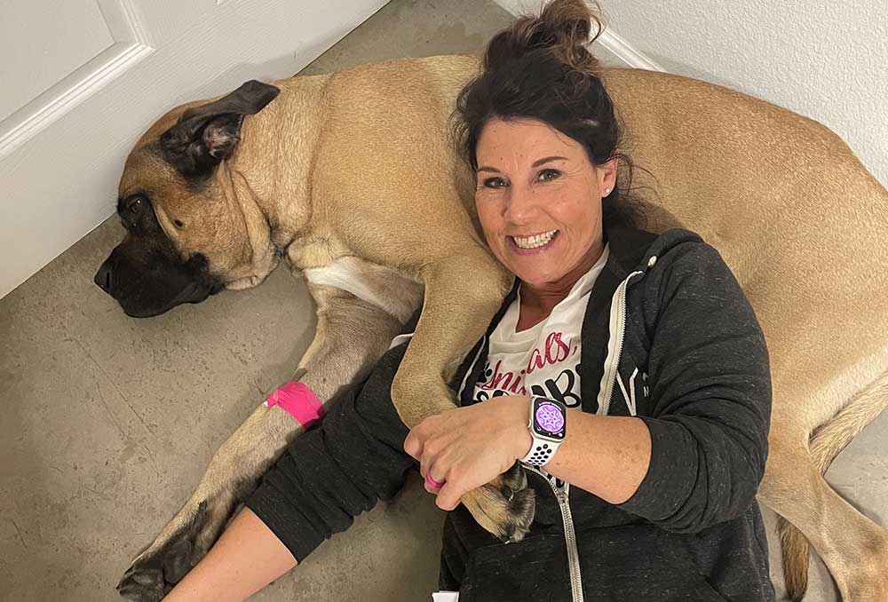 Mobile veterinary technician laying down with a canine patient